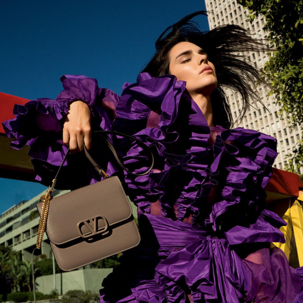 Kendall Jenner in violet dress holding a Taupe Valentino replica bag
