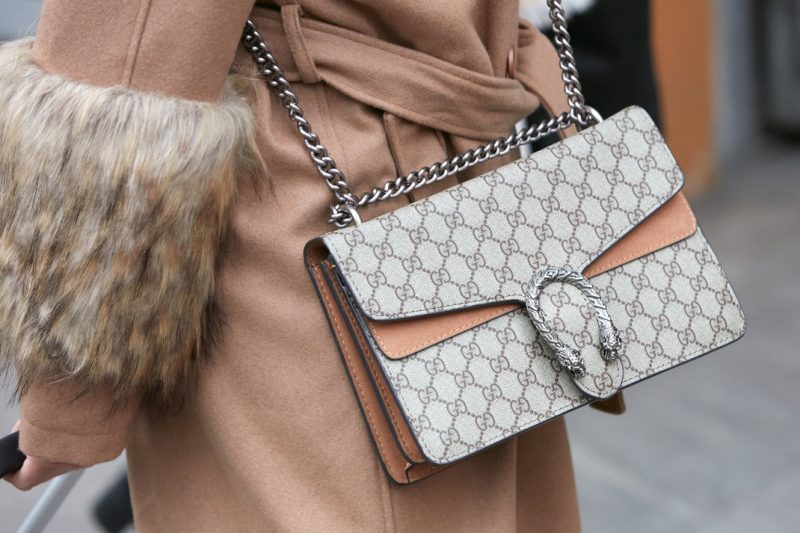 woman carrying fake Gucci Dionysus canvas shoulder bag