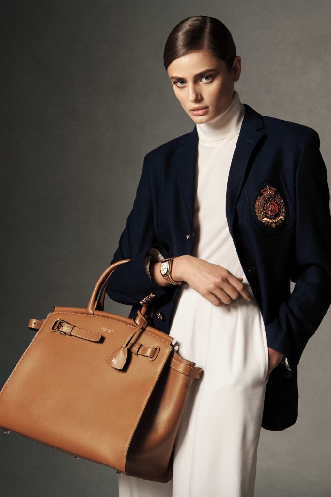 lady flaunting her fake designer bag on her forearm