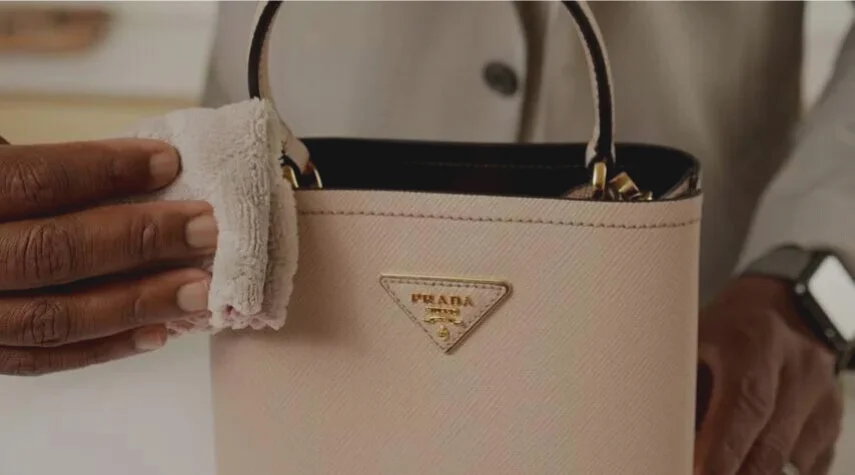 Prada replica bag being polished with cloth